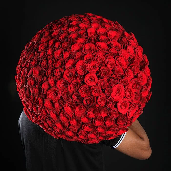 0019__36a3857.jpg Beautiful round bouquet featuring 250 red roses held by a man.