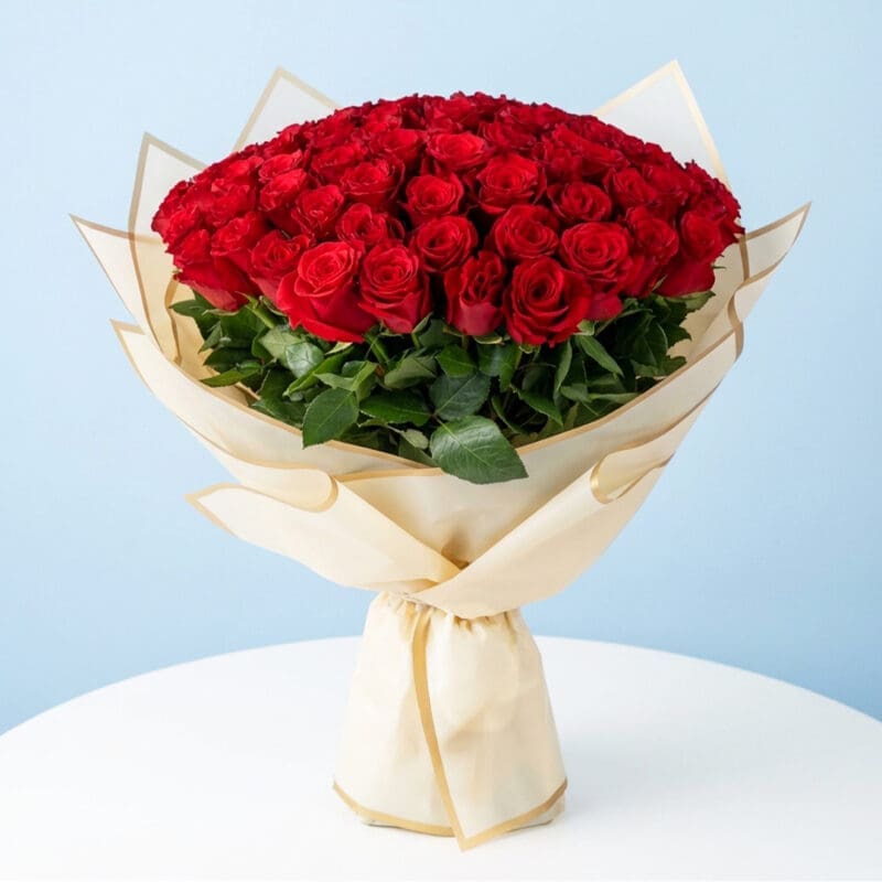 A 100 red roses bouquet wrapped in half white wrap.