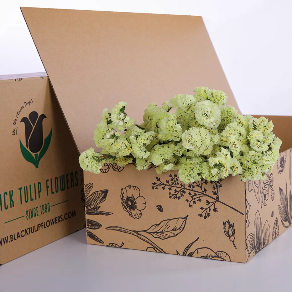 Statice Yellow A cardboard box filled with vibrant yellow Statice flowers, showcasing their bright colour and delicate texture.