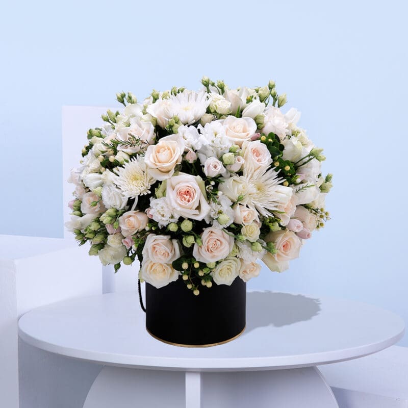 01 (17) A mix of roses, spray roses, chrysanthemums, lisianthus, hypericum, and seasonal fillers in a black, easy-to-carry box.