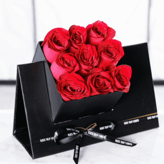 9 vibrant red roses beautifully presented in a black cube box tied with black ribbon.