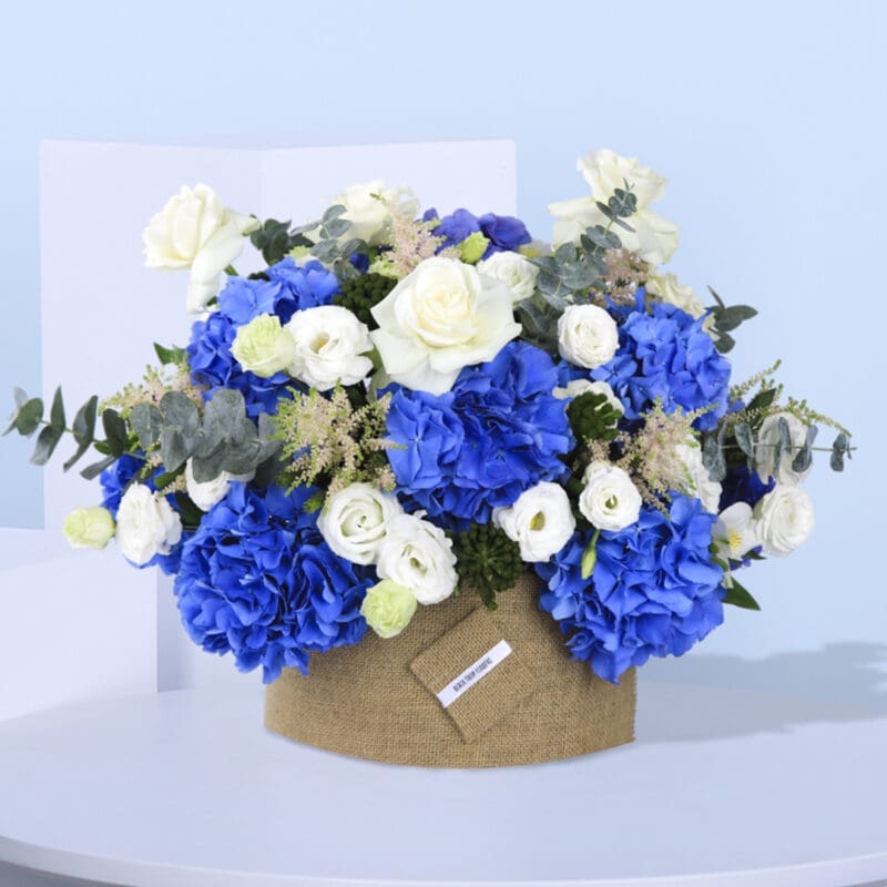 1 (57) Beautiful floral centerpiece with a mix of blue hydrangeas and white roses