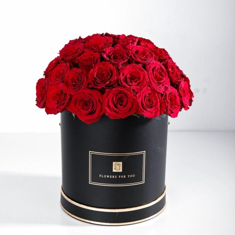 Classic Red (1) 30-40 stems of vibrant red roses elegantly arranged in a black round box with "Flowers For You" written on it.