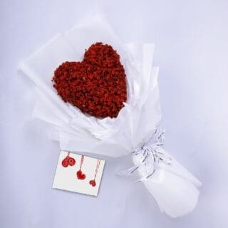 Stunning spray-painted red heart-shaped gypsophila bouquet in a white wrap with a message card.