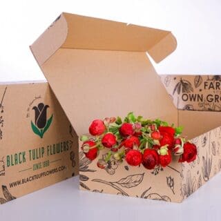 A collection of red Ranunculus flowers arranged in a cardboard box, highlighting their striking appearance and natural beauty.
