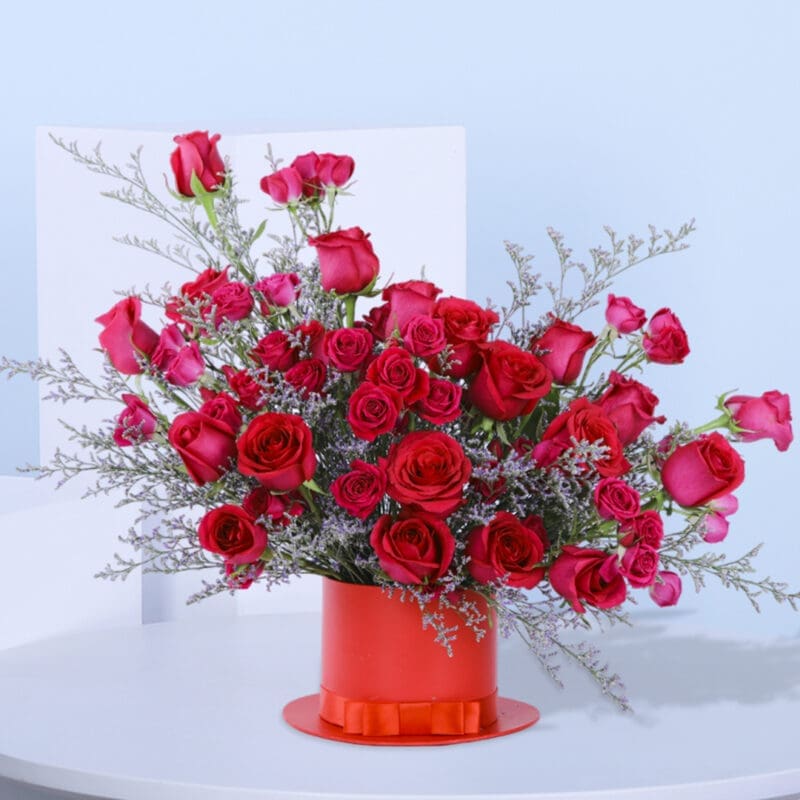 1 (62) Luxurious dark pink spray roses with Caspia fillers in a red hat box with a bow.