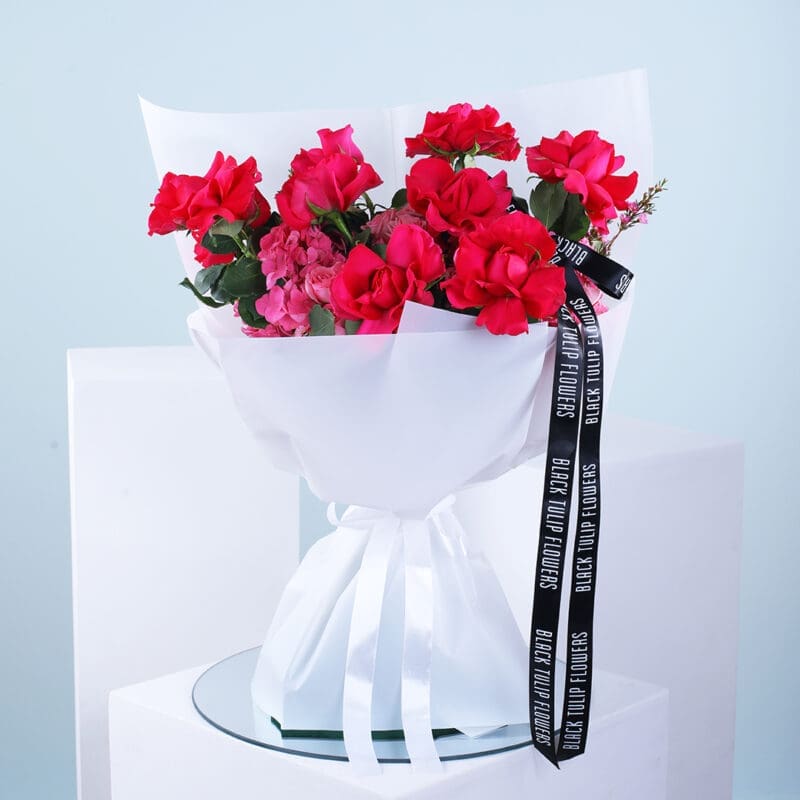 01 Beautiful bouquet of 10 pink roses, 4 hydrangeas, and wax pink wrapped in a white sheet and ribbon.