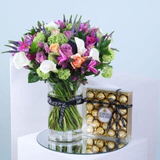 Mixed flowers in glass vase with Ferrero Rocher