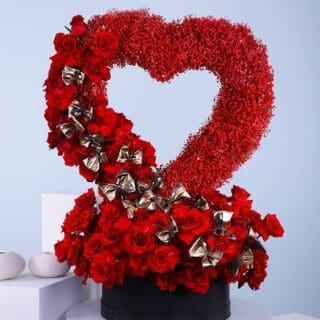 Standing heart shape deep love flower box arrangement, featuring red roses, and red sprayed gypsophilla in a black box.