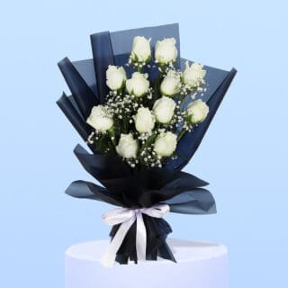 White roses and gypsophila wrapped in sleek black, tied with a classic white ribbon.