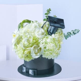 White graduation flower box with Hydrangea, Polister, Phalaenopsis bloom, and Eucalyptus