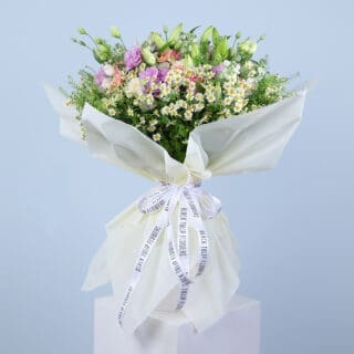 A large, colorful bouquet featuring pink gerberas, pink roses, white ohara, tanacetrum, bublurium, white lilies and more
