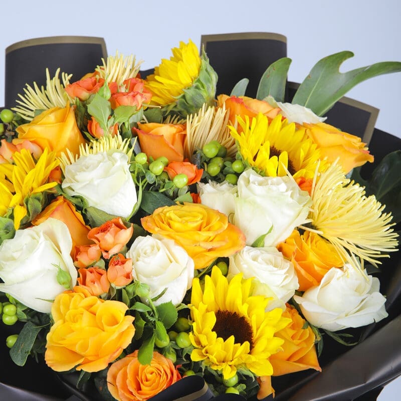 Close-up view Yellow theme bouquet with a mix of white and orange flowers