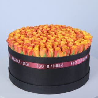 120 orange roses in a black hat box with Pink ribbon