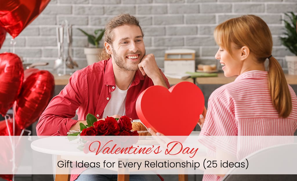 A girl, holding a gift card in her hand, her boy sitting next to her in a hotel decorated with Valentine's Day balloons and flowers.