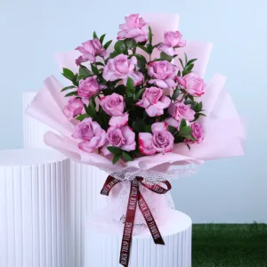 A beautiful bouquet of soft lavender roses is elegantly presented, their delicate petals displaying subtle variations in shade