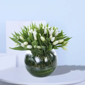Celebrate Dad in style with this stunning arrangement of 50 stems of white tulips in a sleek glass vase. Each pristine bloom symbolizes purity and admiration, making it the perfect gift to honor the extraordinary man in your life on Father’s Day.