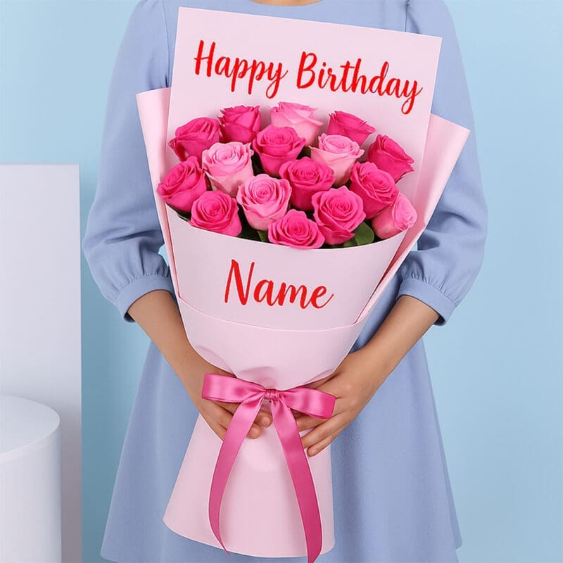 roses-birthday-bouquet A bouquet of pink roses, wrapped in soft pink, featuring “Happy Birthday” at the top and a personalized name at the bottom. A pink ribbon is tied in a bow around the bouquet.