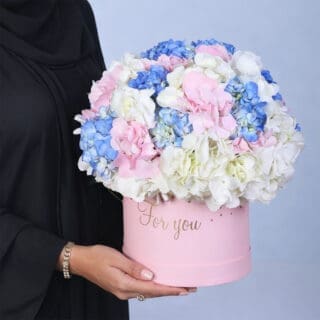 Rounded hydrangea cluster in blended soft colours, beautifully presented in a modern pink floral box