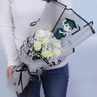 White rose bouquet is carefully arranged in a hand-tied style, wrapped in premium gift paper with ribbon accents, designed to celebrate graduation day.