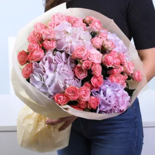 Elegant floral bouquet arranged beautifully in a vibrant and luxurious hand-tied style.
