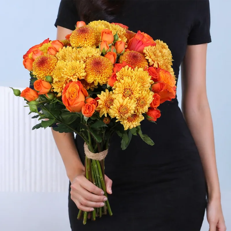 radiant-orange-flower-bunch Orange flower bunch arranged in a vibrant and warm style, wrapped neatly for a cheerful presentation.