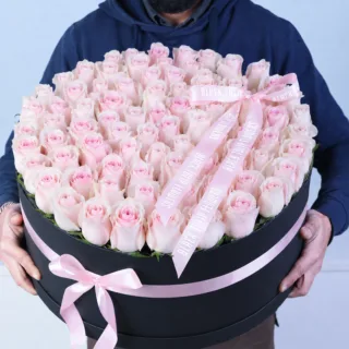 Luxury flower box containing fresh roses presented in a neat, structured arrangement with a smooth and elegant visual appeal.
