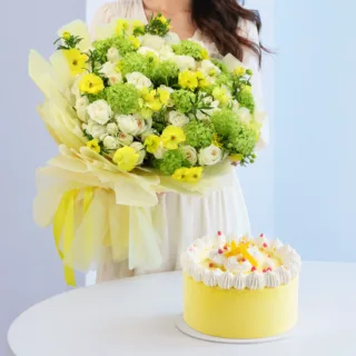 Stylish flower bouquet with cream and yellow blooms paired with a refreshing mango ice cream cake bundle