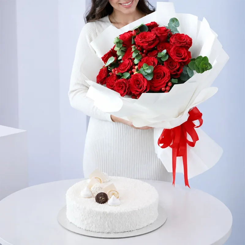 luxury-rose-raffaello-cake-combo Premium floral arrangement featuring red roses, green fillers, and berries combined with a 1 kg Raffaello Cake for online gift delivery