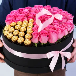 Gift combo featuring a large arrangement of fresh pink roses paired with a premium chocolate box, designed in an elegant presentation for celebrations and gifting occasions.