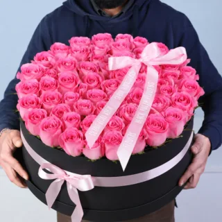 Fresh rose round box featuring tightly arranged blooms in a stylish circular container, creating a clean and premium gift presentation.