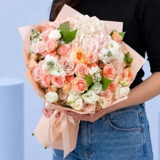 Mixed rose floral bunch arranged in a hand-tied style with natural spacing, showcasing freshness and a light, joyful composition.
