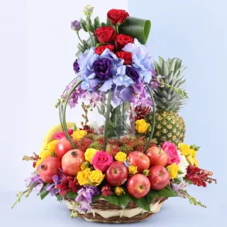 A beautifully arranged basket of fresh seasonal fruits and colorful flowers designed for gifting.