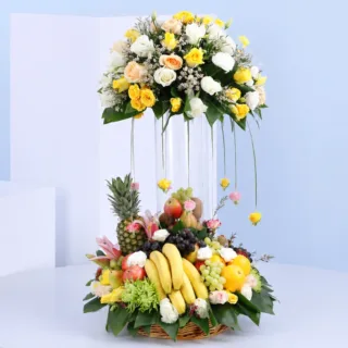 Elegant fruits and flowers with fresh produce and seasonal blooms beautifully styled as a tower arrangement.