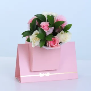 Blush Rose Floral Envelope Box featuring 3 fresh pink roses, 3 white roses, and 5 stems of lush ruscus arranged in a premium floral envelope box for gifting and special occasions.