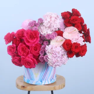 Exquisite Floral Hat Box featuring red roses, dark pink roses, light pink hydrangeas, purple spray roses, anthuriums, and light pink Deco chrysanthemum beautifully arranged in a premium hat box.