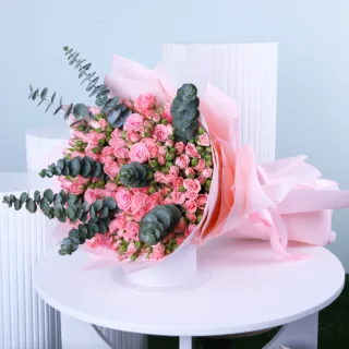 Pink Rose Bouquet with Eucalyptus featuring fresh pink roses, pink spray roses, and eucalyptus beautifully arranged in an elegant hand bouquet.