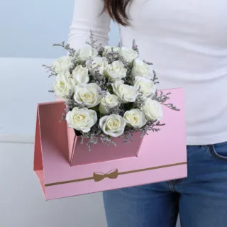 White Spray Rose Pink Envelope Box featuring 6 stems of fresh white spray roses with delicate caspia arranged in a premium pink envelope-style flower box.