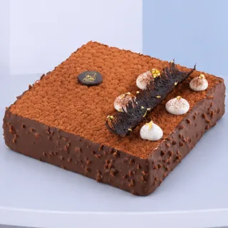 1Kg Premium Tiramisu Cake with a rich cocoa dusting, creamy layers and elegant chocolate decoration, perfect for birthdays and special celebrations.