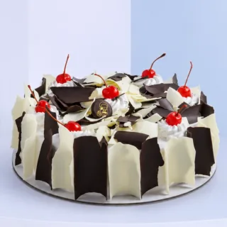 1kg Rich Black & White Forest Cake | EL with chocolate and vanilla sponge, creamy layers, dark and white chocolate flakes.