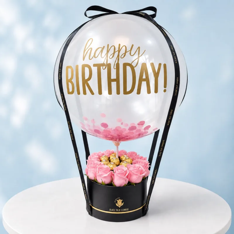 birthday-pink-rose-ferrero-box Birthday Pink Rose Ferrero Box with Happy Birthday Balloon, featuring fresh pink roses and delicious Ferrero Rocher chocolates, beautifully arranged in an elegant black gift box for celebrations.