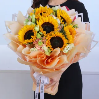 Sunflower Blossom Bouquet featuring fresh sunflowers with white and peach lisianthus in premium floral wrapping.