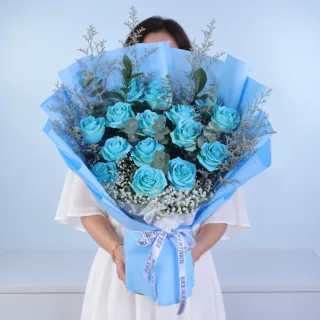 Blue Rose Majesty Bouquet featuring vibrant blue painted roses, purple caspia, eucalyptus cinerea, white gypsophila, and ruscus, beautifully arranged for birthdays, celebrations, anniversaries, and thoughtful gifting.