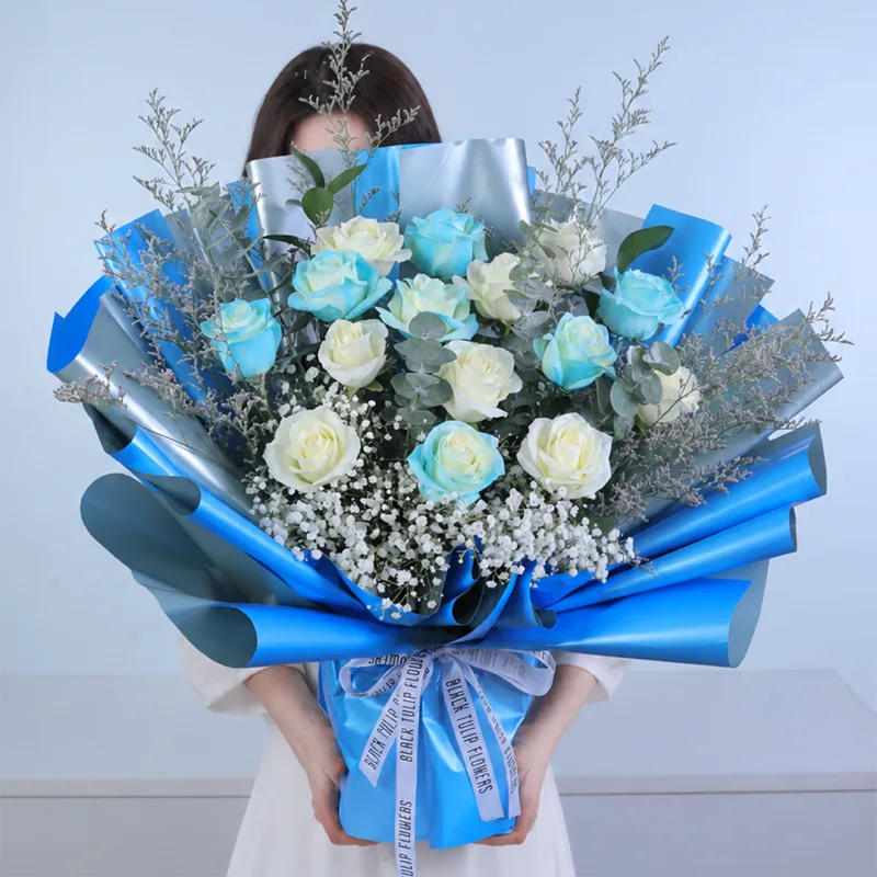 blue-white-rose-harmony-bouquet Blue and white rose harmony bouquet featuring fresh white roses, blue painted roses, purple caspia, eucalyptus cinerea, and white gypsophila, beautifully arranged for birthdays, celebrations, and gifting.