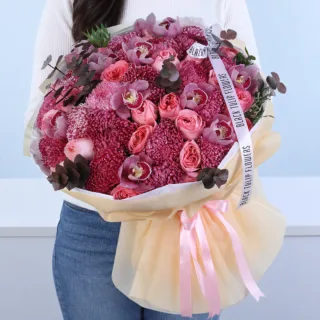 Pink Blossom Luxury Bouquet featuring pink roses, dyed red chrysanthemum blooms, pink Cymbidium orchids, painted cinerea foliage, beautifully arranged as a grand floral gift for celebrations.