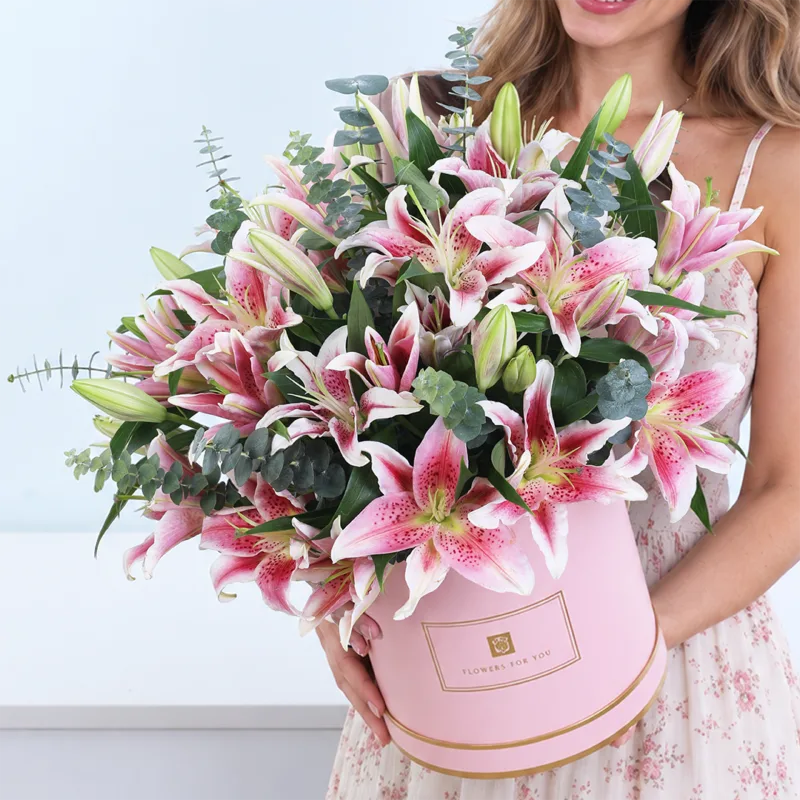 pink-lily-paradise Pink Lily Paradise featuring pink Oriental lilies and Baby Blue eucalyptus arranged in a premium pink hatbox.