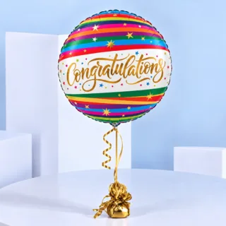Rainbow Congratulations Helium Balloon with vibrant multicoloured stripes, gold decorative stars, and elegant lettering on a white background.