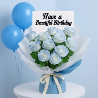 BTF Home 93 A beautiful bouquet of light blue roses, wrapped in white and blue paper, on a white table with three blue balloons.