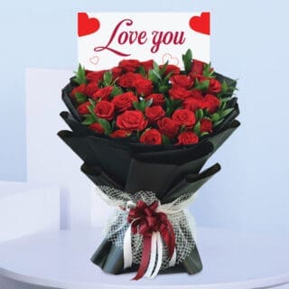 BTF Home 42 Love You bouquet featuring red roses hand-tied in black wrapping with a red and white ribbon and “Love You” card.