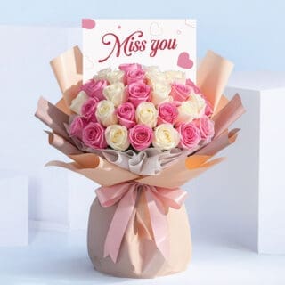 BTF Home 41 Miss You bouquet featuring pink and white roses hand-tied in blush wrapping with a satin ribbon and “Miss You” card.